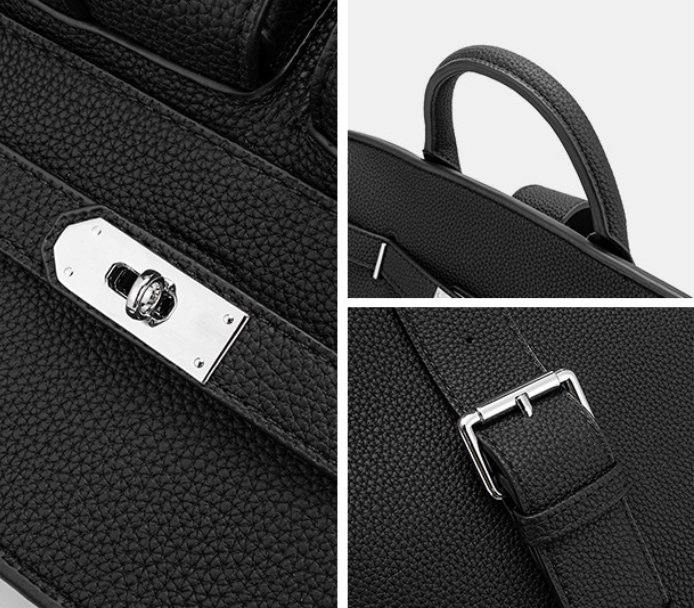 Close-up of a black leather bag with silver hardware on a white background
